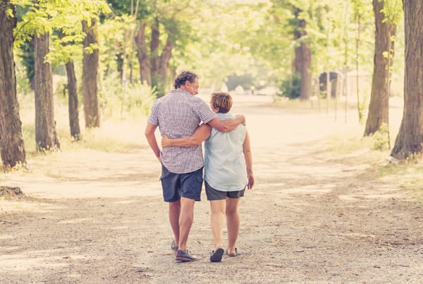 Happy Senior Couple Walking And Enjoying Life Outdoors
